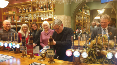 The Very Reverend Philip Hesketh pulling the first pint